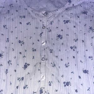 White long-sleeve floral shirt.